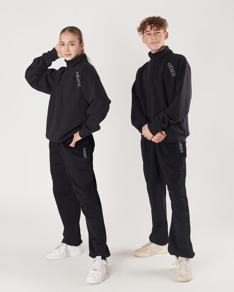 KNDRCK pulover s polzadrgo - črn